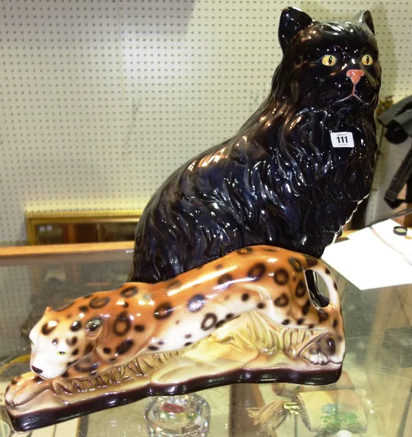 A large 20th century black ceramic cat and a smaller leopard, (2).ROST
