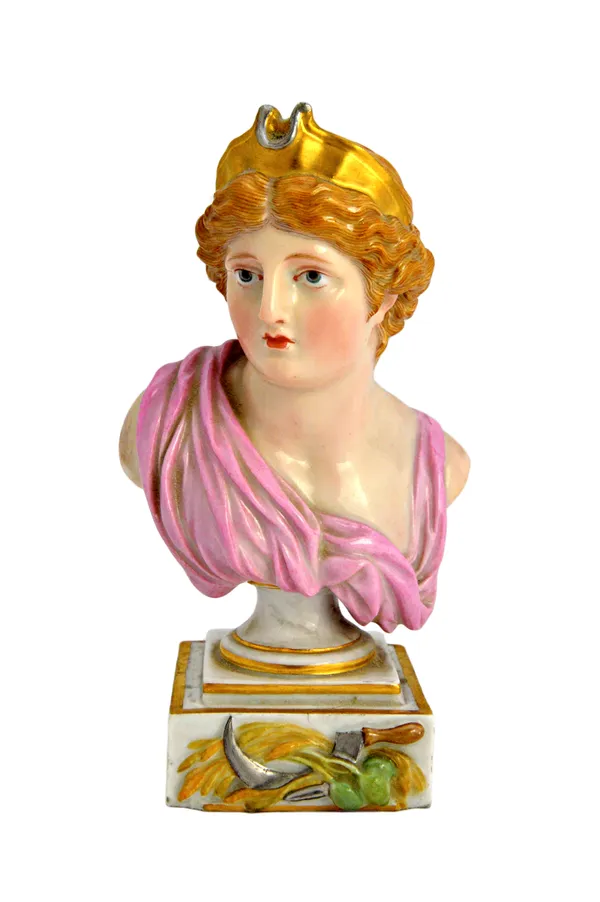 A Meissen porcelain bust, late 19th century, depicting 'Diana', on a socle and square base relief mounted with scythe and harvest produce, underglaze