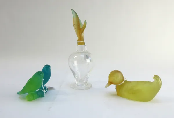 A pair of Daum coloured glass budgerigars atop a branch, etched 'Daum France', 7cm high, a Daum yellow glass duck, 11.5cm wide, and a Daum scent bottl