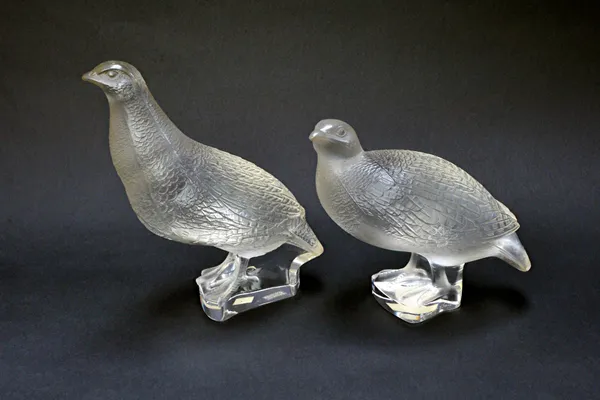 A Lalique clear and frosted crystal model of a quail, etched 'Lalique France' to the base, 18cm high, and one smaller Lalique quail, 13.5cm high (2).