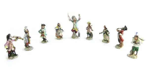 A set of nine Sitzendorf monkey band porcelain figures, 20th century, including The Conductor, blue printed marks to base, 15.5cm high (9).