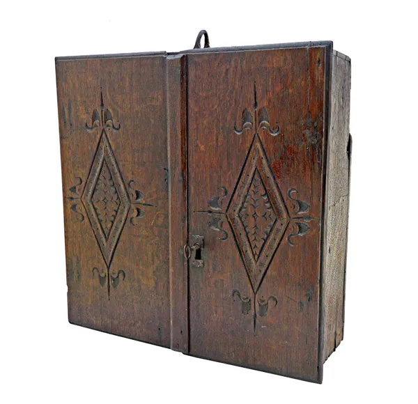 A Charles II oak hanging cupboard, with pair of carved doors and iron hanging hook, 51cm wide x 50cm high.   Illustrated