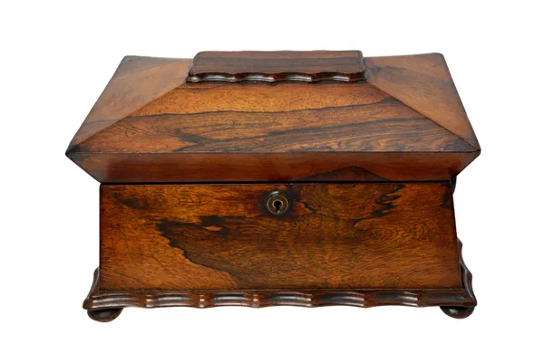A late Regency rosewood tea caddy of sarcophagus form, with twin lidded interior, 37cm wide x 27cm deep.   Illustrated
