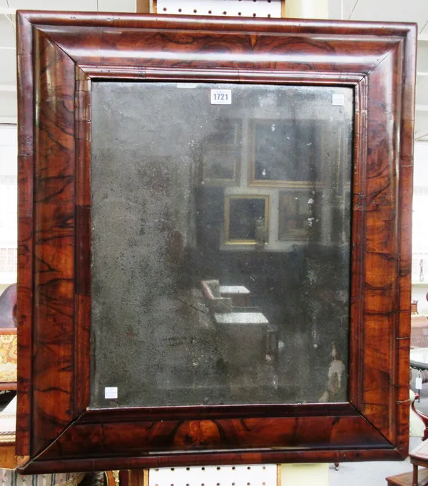 A 17th century and later figured walnut rectangular cushion framed wall mirror, 65cm wide x 73cm high.