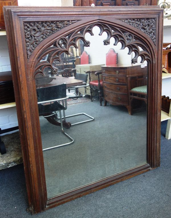 A Victorian Gothic Revival oak framed wall mirror, with pierced arch decoration, 125cm wide x 146cm high.