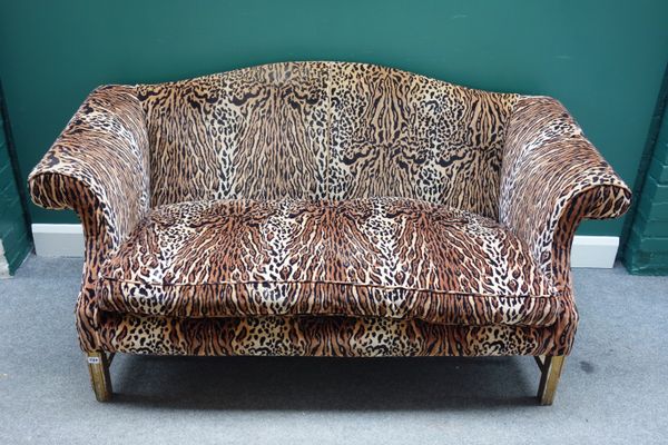 Peter Stringfellow's, Angels Club; a pair of 20th leopard print upholstered hump back sofas on block supports, each 177cm wide x 87cm high. Sold with