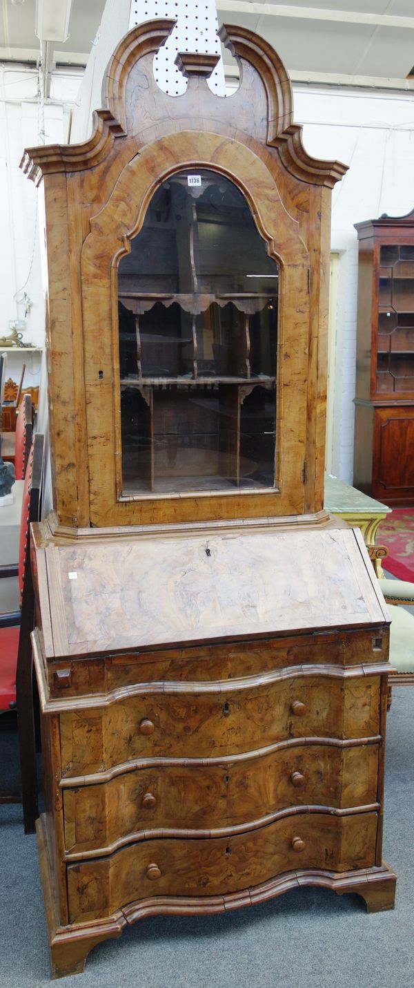 A late 19th century Continental figured walnut bureau cabinet, with single arched glazed door over fall and three long serpentine drawers, 83cm wide x