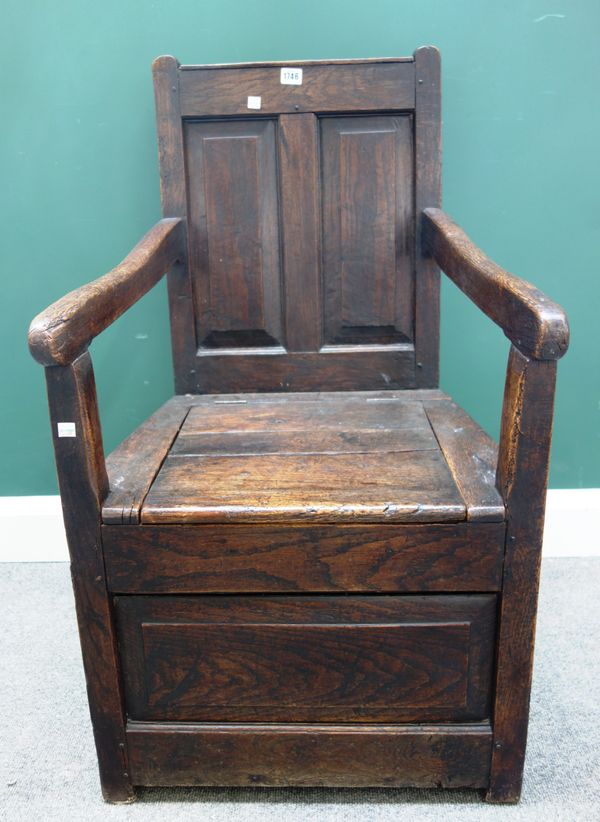 A George III oak box seat panel back open armchair, 56cm wide x 97cm high.