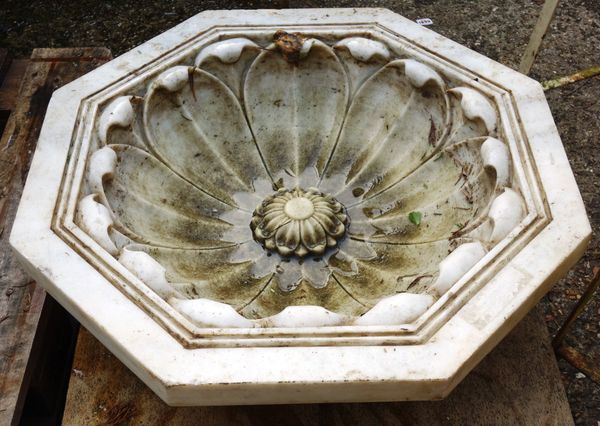 A 20th century carved marble octagonal planter, relief carved with a lotus flower, 66cm wide x 19cm high.