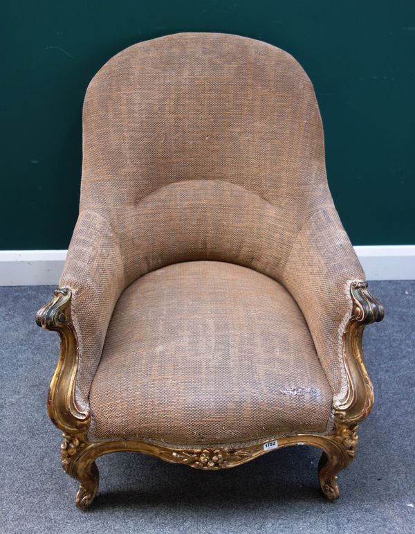 A Victorian gilt framed tub back armchair, with serpentine seat and scroll supports, 67cm wide x 90cm high.