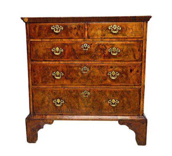 A George I feather banded figured walnut chest of two short and three long graduated drawers, on bracket feet, 101cm wide x 58cm deep.   Illustrated