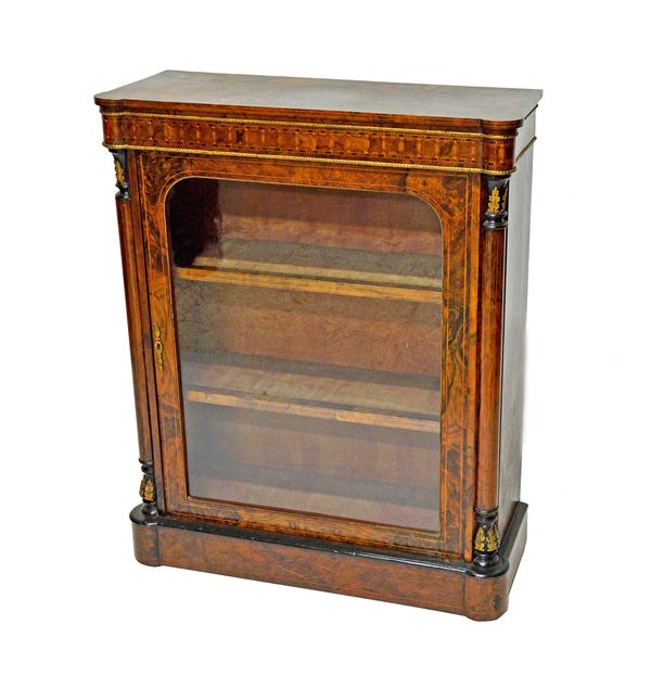 A Victorian gilt metal mounted figured walnut pier cabinet, with single glazed door, on plinth base, 84cm wide x 104cm high.   Illustrated