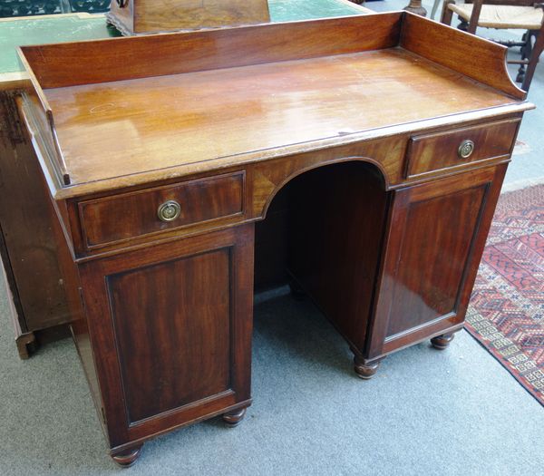 A Victorian mahogany knee hole writing desk, with pair of drawers over cupboards, 102cm wide x 42cm deep.