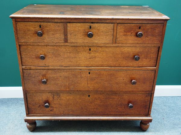 A Victorian oak chest, the three short and three long drawers on tall bun feet, with pencil signature to underside of drawer, 116cm wide x 109cm high