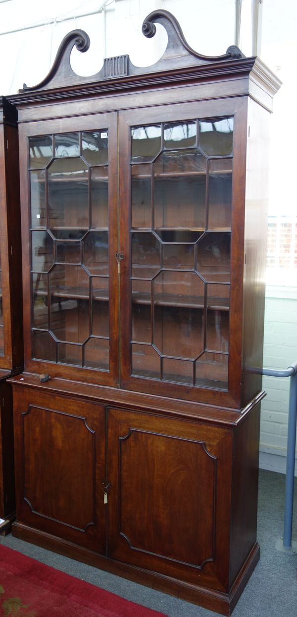 A George III (later adapted) mahogany bookcase cupboard, the pair of astraglaze doors over a pair of cupboards, 133cm wide x 260cm high.