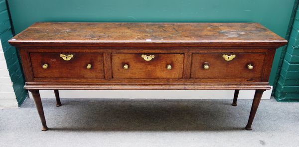 An 18th century oak dresser base, with three frieze drawers on club supports, 190cm wide x 51cm deep.