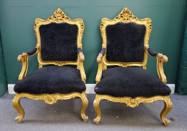 Peter Stringfellow's, Angels Club; a pair of gilt framed open arm throne chairs, with black upholstery on scroll supports, each 80cm wide x 120cm high