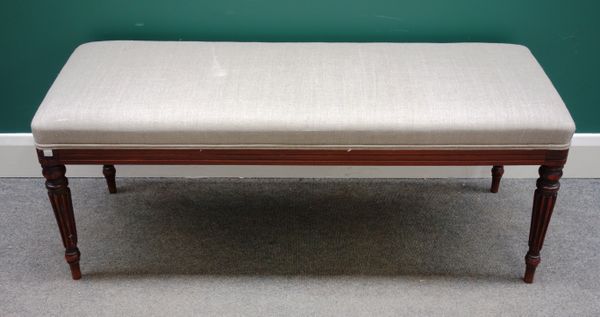 A rectangular footstool on four William IV mahogany reeded supports, 120cm wide x 50cm deep.