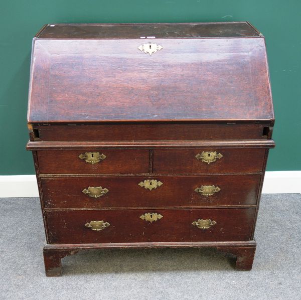 An early 18th century oak bureau, with stepped and welled interior over two short and two long drawers, on bracket feet, 92cm wide x 52cm deep.