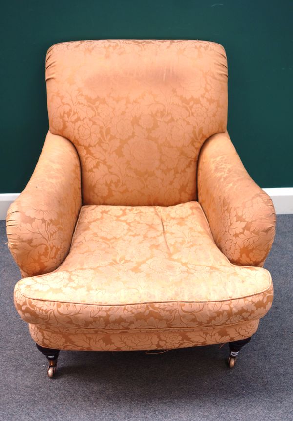 A Howard style easy armchair on turned supports, 85cm wide x 92cm high.