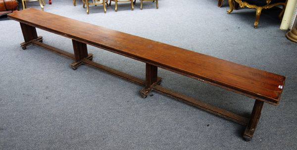 A pair of late Victorian oak long benches, each with rectangular top on four moulded supports and ball feet, 304cm wide x 45cm high x 34cm deep (2).