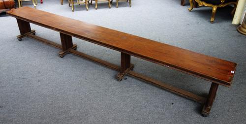 A pair of late Victorian oak long benches, each with rectangular top on four moulded supports and ball feet, 304cm wide x 45cm high x 34cm deep (2).