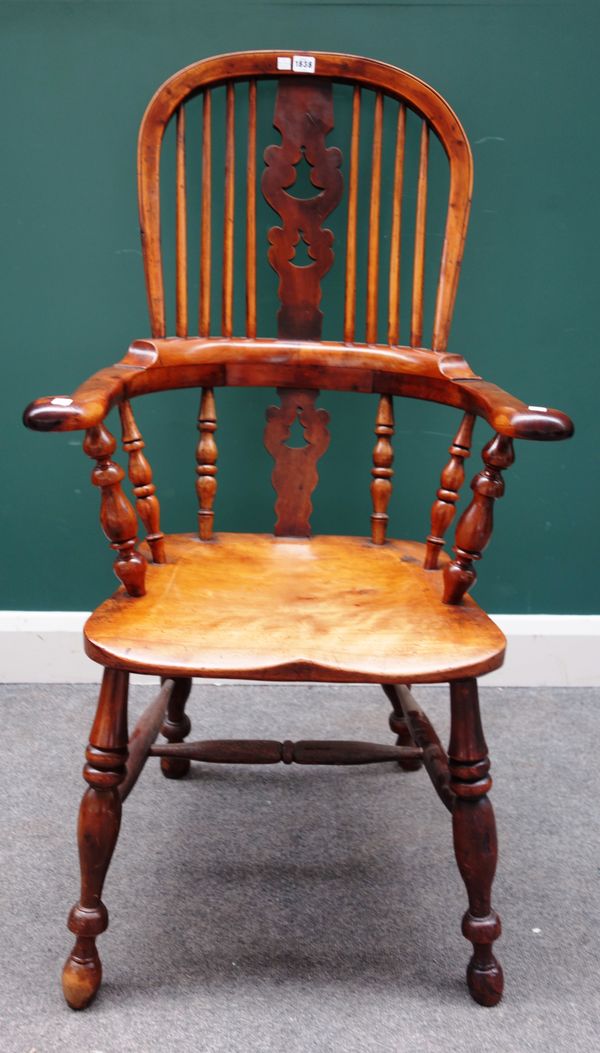 A mid-19th century yew back Windsor chair, with Christmas tree pierced splat, on turned supports, 62cm wide x 114cm high.