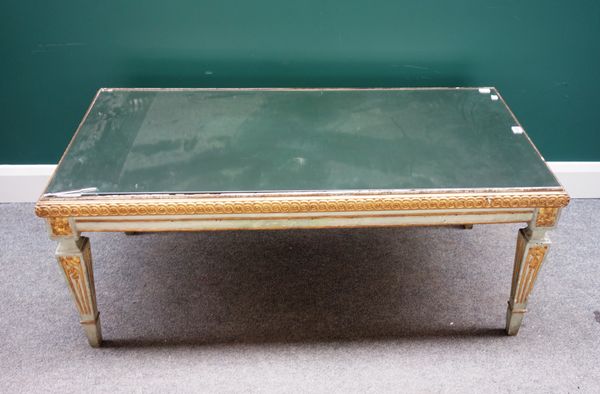 A 19th century Italian parcel gilt polychrome painted rectangular coffee table, with mirrored top on tapering square supports, 64cm x 126cm.