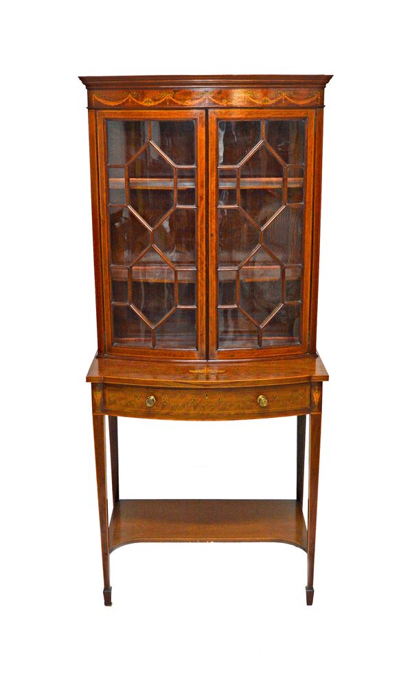 In the style of Edwards & Roberts; a late 19th century marquetry inlaid mahogany bowfront display cabinet, with single drawer on tapering square suppo