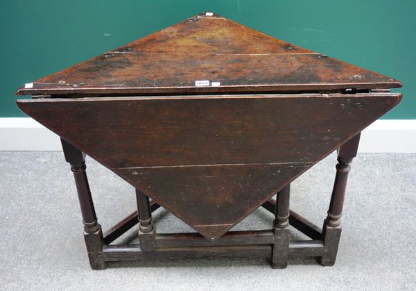 An early 18th century oak corner drop flap/ handkerchief  table on turned supports, 90cm wide x 46cm deep x 90cm deep open.