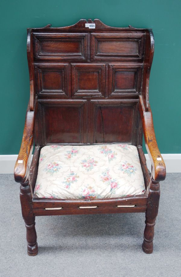 A Charles II and later panelled wing back open armchair, on turned supports, 63cm wide x 101cm high.