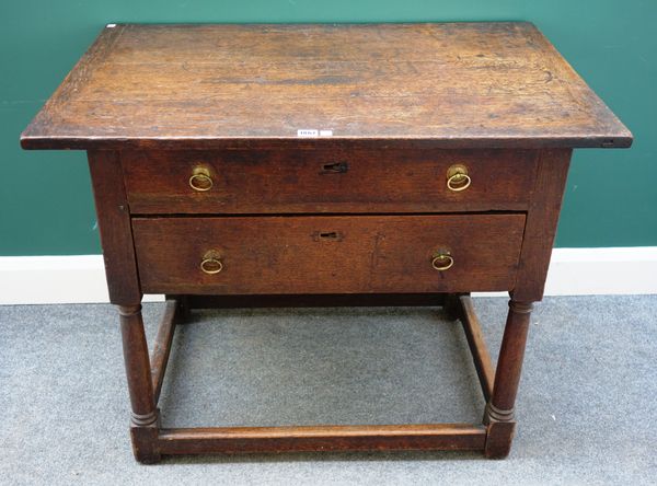 A late 17th century oak two drawer side table, on turned supports united by perimeter stretcher, 96cm wide x 64cm deep.