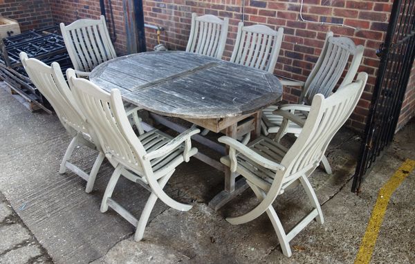 A 20th century oval hardwood extending garden table, 110cm wide x 166cm long x 206cm long extended, together with six folding chairs (7).