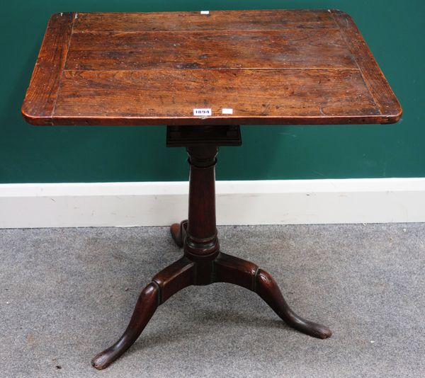 An early 18th century occasional table, the rectangular elm top on an associated oak base, with bird cage mount, turned column and three shallow downs