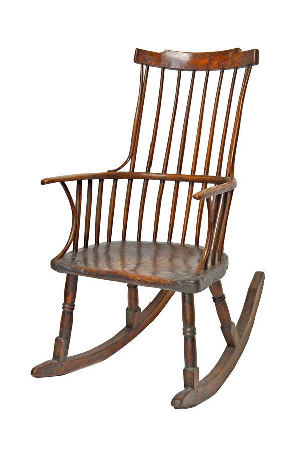 An 18th century ash, elm and fruitwood spindle back rocking chair, on turned supports, 62cm wide x 112cm high.   Illustrated