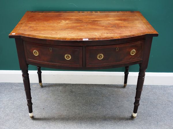 A Regency cross banded mahogany bowfront two drawer side table, on ring turned supports, 96cm wide x 61cm deep.