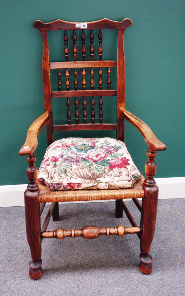 A George III ear back ash and oak open armchair, with triple row bobbin turned back, 57cm wide x 109cm high.