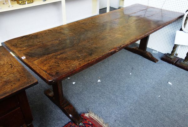 A 17th century and later oak refectory table, with cleated triple plank top on pair of trestle supports, 81cm wide x 220cm long.