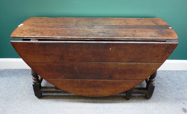 An early 18th century oak gateleg table, on baluster turned supports, 140cm wide x 55cm across x 160cm open.