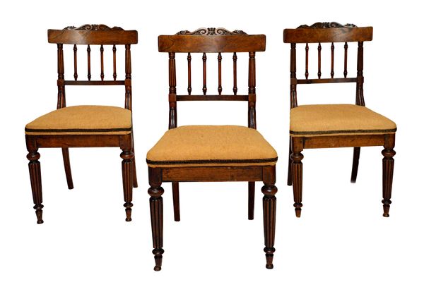 Probably Gillows; a set of eight Regency rosewood dining chairs, with turned spindle backs and lappet mounts, on tapering reeded supports, 47cm wide x