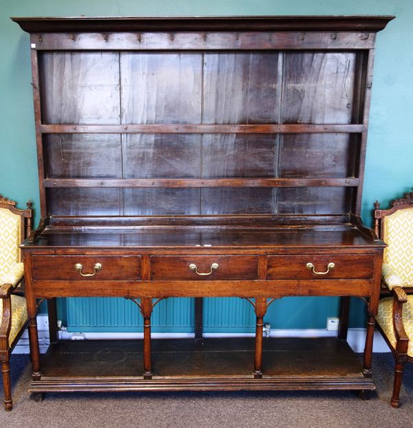 A mid-18th century oak dresser, the enclosed two tier plate rack over three frieze drawers, on turned supports united by potboard undertier, 178cm wid