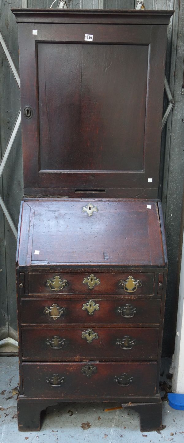 An 18th century oak bureau cupboard of small proportions, with single panel drawer over fitted interior, with four long graduated drawers, on bracket