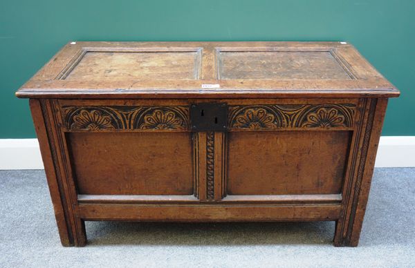 A 17th century oak coffer, with double panel lid and front on stile feet, 107cm wide x 51cm deep.