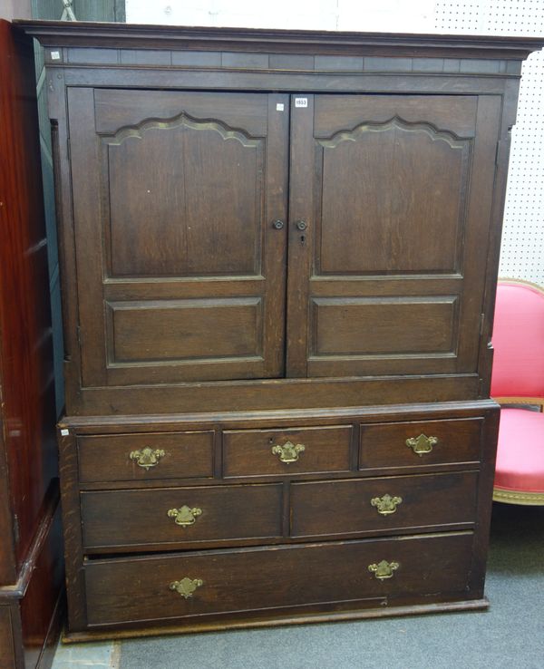 A mid-18th century oak bacon cupboard, with pair of shaped panel doors over six various drawers, 137cm wide x 176cm high.