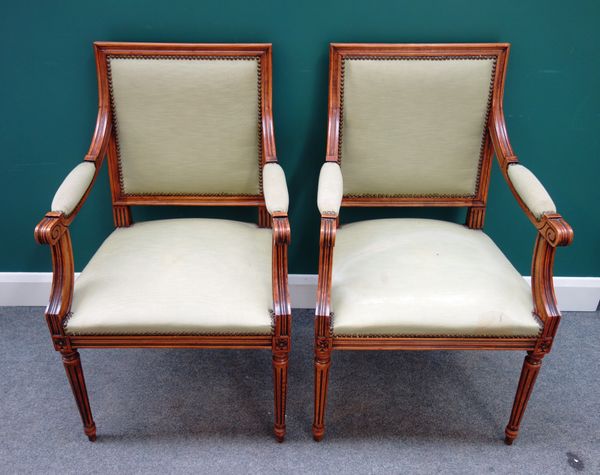 A pair of Louis XVI style beech framed square back open armchairs, on tapering fluted supports, each 59cm wide x 100cm high (2).