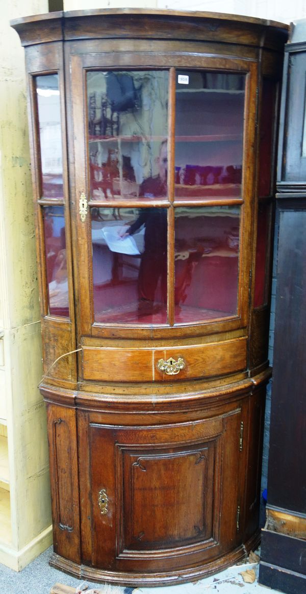 A late 18th century French oak corner display cabinet/cupboard, with single glazed door over drawer and cupboard, 95cm wide x 196cm high.