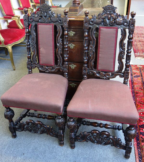 A pair of Carolean style oak framed side chairs, with carved decoration and bulbous supports, 53cm wide x 113cm high.