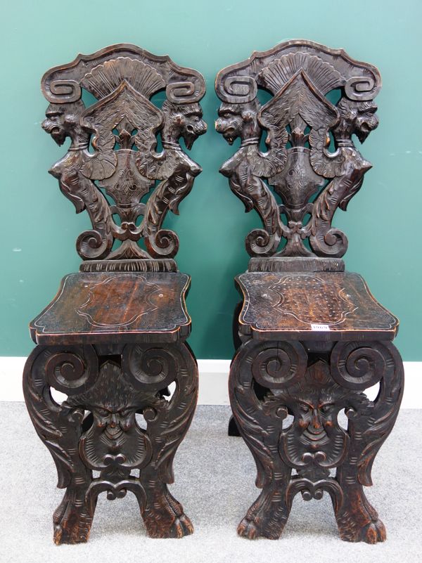 A pair of 17th century style Italian carved walnut side chairs, of Sgabello design, each 32cm wide x 102cm high (2).