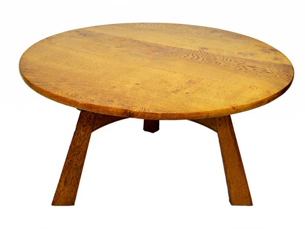 Ian Weston; a contemporary Cotswold school oak centre table, incised monogram and dated 04, the circular bowed plank top with flowerhead tenon detaili