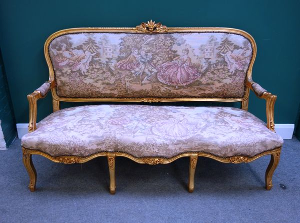 A Louis XV style gilt framed open arm sofa, with triple bow seat on cabriole supports, 165cm wide x 105cm high.